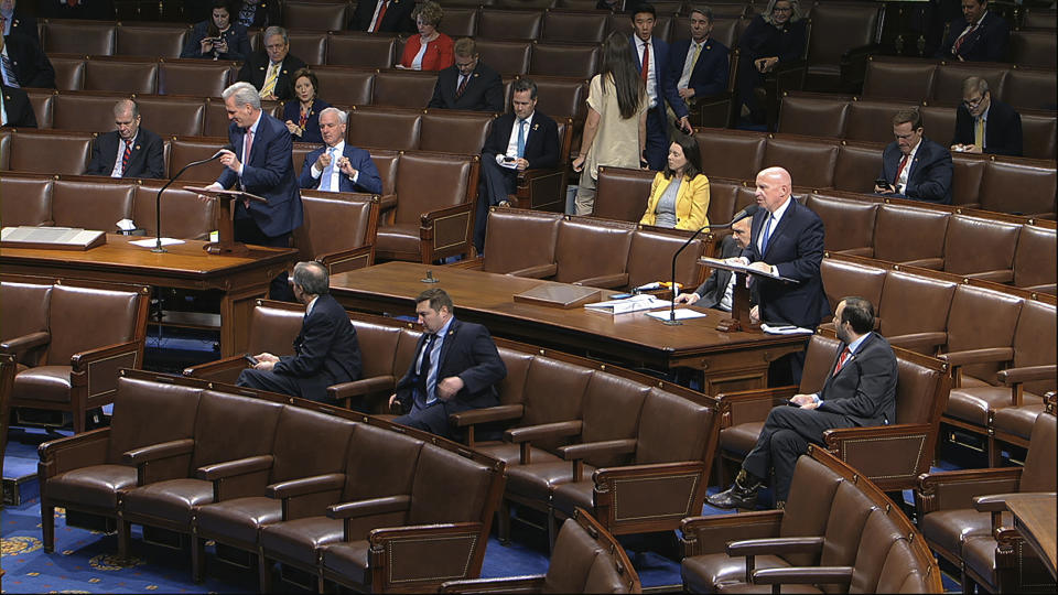 In this image from video, Rep. Kevin McCarthy, R-Texas, left, and Rep. Kevin Brady, R-Texas, stand as they speak on the floor of the House of Representatives at the U.S. Capitol in Washington, Friday, March 27, 2020. (House Television via AP)