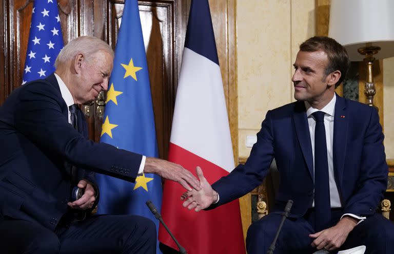 U.S. President Joe Biden, left, shakes hands with French President Emmanuel Macron during a meeting at La Villa Bonaparte in Rome, Friday, Oct. 29, 2021. A Group of 20 summit scheduled for this weekend in Rome is the first in-person gathering of leaders of the world's biggest economies since the COVID-19 pandemic started. (AP Photo/Evan Vucci)