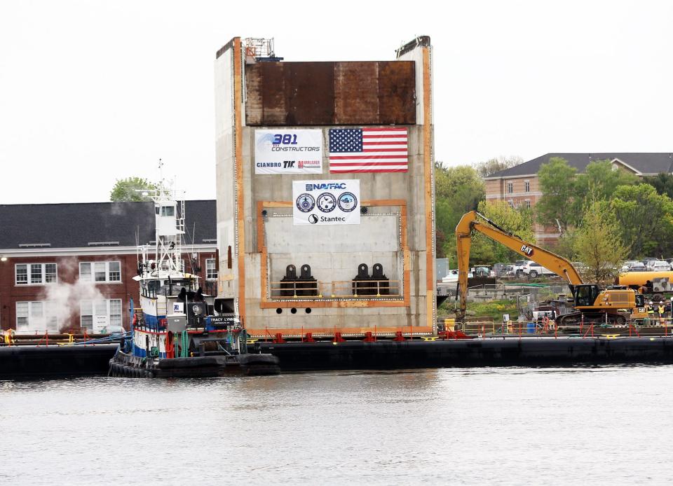 The first of 27 concrete monolith structures floats on the Piscataqua River Thursday, May 16, 2024 en route to Portsmouth Naval Shipyard for the $1.8 billion dry dock expansion project.
