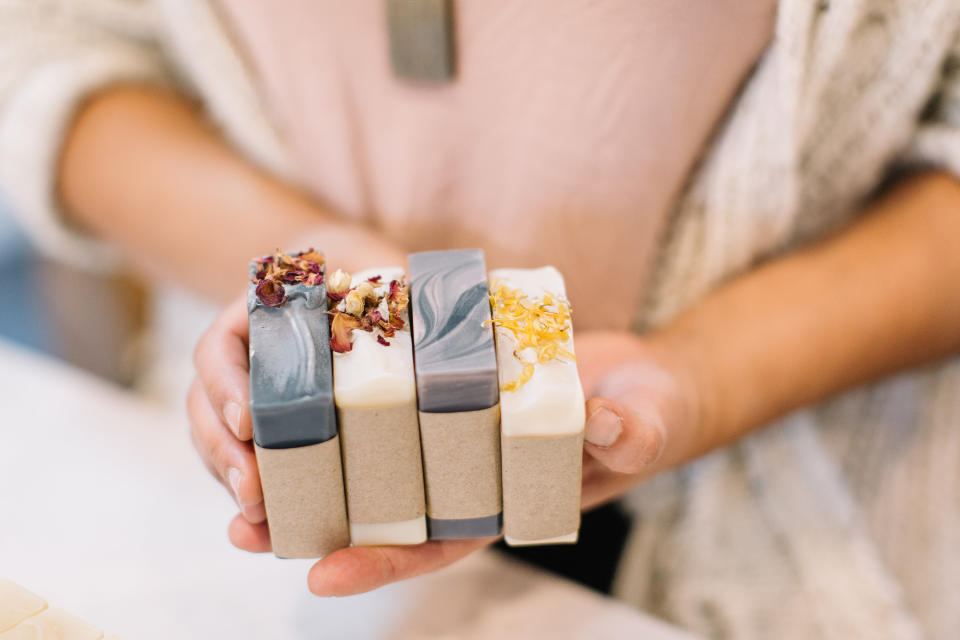 hands hold homemade bars of soap