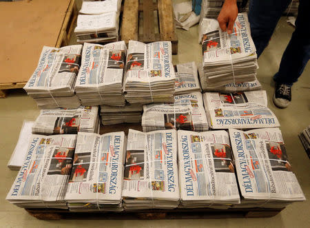 Copies of the daily newspaper Delmagyarorszag are stacked hot off the press at publishing house Lapcom's press room in Szeged, Hungary, November 9, 2016. REUTERS/Laszlo Balogh