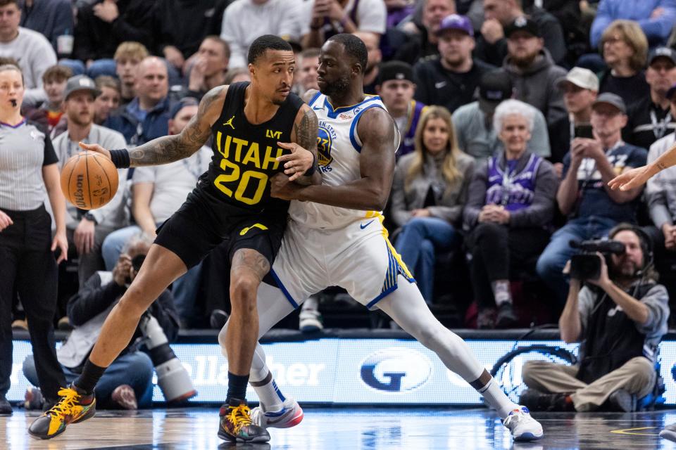Utah Jazz forward John Collins (20) looks to pass the ball past Golden State Warriors forward Draymond Green (23) during a game at the Delta Center in Salt Lake City on Monday, Feb. 12, 2024. | Marielle Scott, Deseret News
