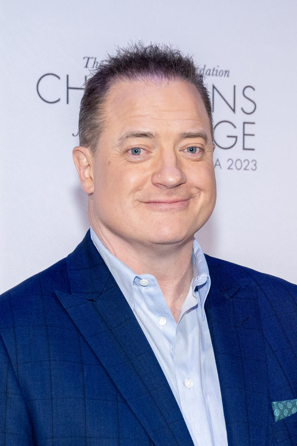 Brendan Fraser posing at a charity event