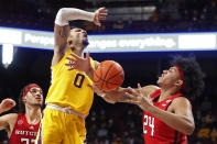 Rutgers guard Ron Harper Jr. (24) knocks the ball away from Minnesota guard Payton Willis (0) as Caleb McConnell, far left, watches in the first half of an NCAA college basketball game Saturday, Jan. 22, 2022, in Minneapolis. (AP Photo/Bruce Kluckhohn)