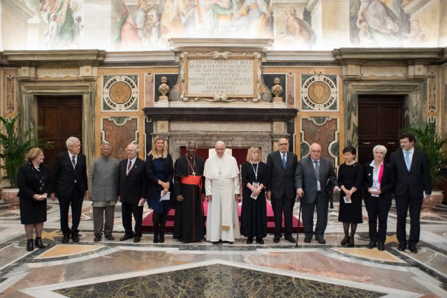 Francis poses with participants in the International symposium on a nuclear weapons free world