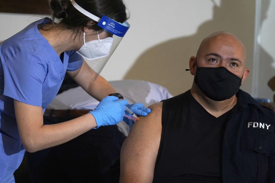 New York City firefighter emergency medical services personnel are vaccinated against COVID-19 at the FDNY Fire Academy in New York, Wednesday, Dec. 23, 2020. (AP Photo/Seth Wenig)