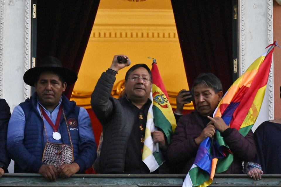 Bolivian President Luis Arce (C) talks from the balcony of the Government Palace in La Paz (AFP via Getty Images)