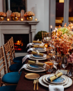 <p>As the days get shorter, follow in accordance with nature and opt for moody candle lighting. Mixed with an orange floral arrangement, it makes for an easy Thanksgiving centerpiece.</p>