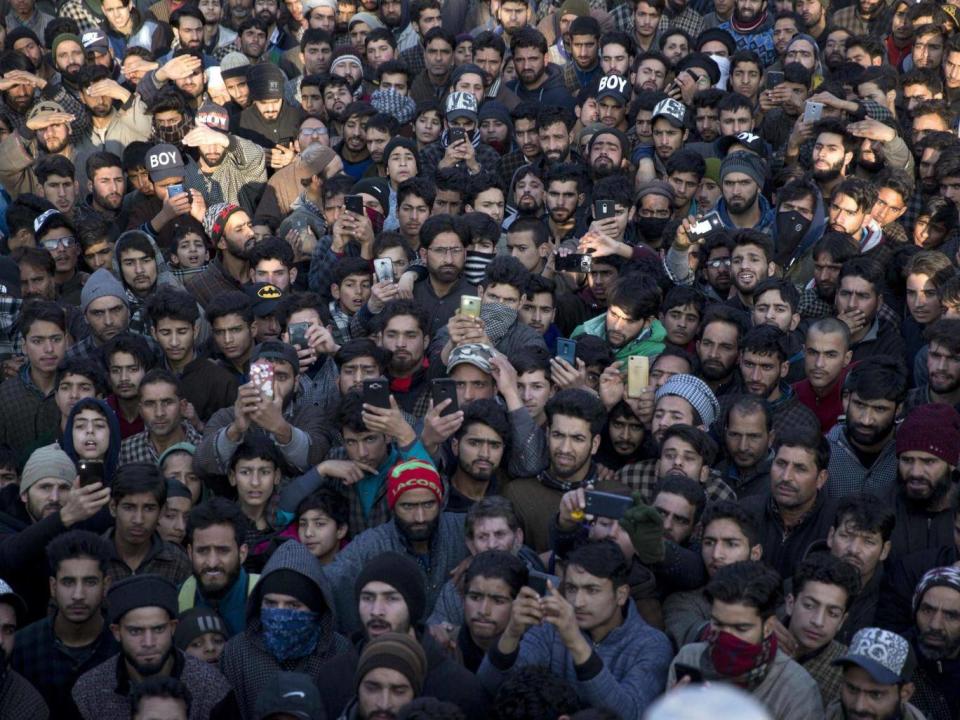 Kashmiri villagers attend the joint funeral of a civilian and rebel killed in a gun battle (AP)