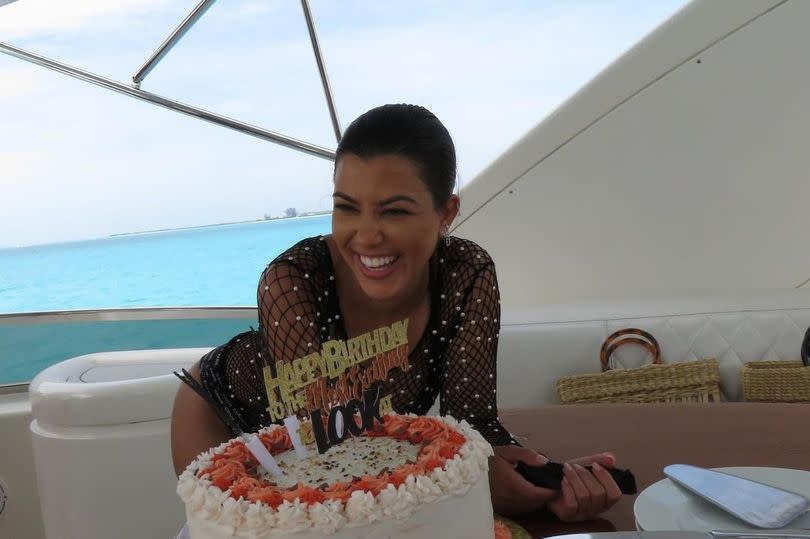 Kourtney Kardashian blows out the candles on her birthday cake