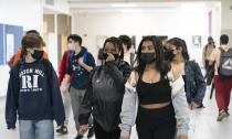 FILE - In this April 22, 2021, file photo, White Plains High School students walk between classes in White Plains, N.Y. Dozens of school districts around the country have eliminated requirements for students to wear masks, and many more are likely to ditch mask requirements before the next academic year. (AP Photo/Mark Lennihan, File)