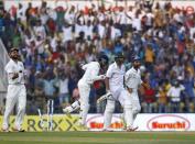 India's captain Virat Kohli (L), wicketkeeper Wriddhiman Saha (2nd L) and Ajinkya Rahane (R) celebrate the dismissal of South Africa's Imran Tahir (2nd R) during the first day of their third test cricket match in Nagpur, India, November 25, 2015. REUTERS/Amit Dave