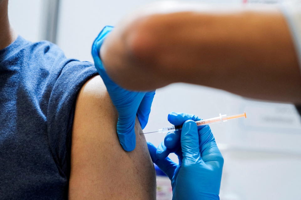 A local resident receives a booster shot of the Moderna coronavirus disease (COVID-19) vaccine at a mass vaccination center operated by Japanese Self-Defense Force, in Tokyo, Japan, January 31, 2022. Eugene Hoshiko/Pool via REUTERS