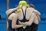 The team from Australia celebrates after winning the final of the women's 4x100m freestyle relay at the 2020 Summer Olympics, Sunday, July 25, 2021, in Tokyo, Japan. (AP Photo/Charlie Riedel)