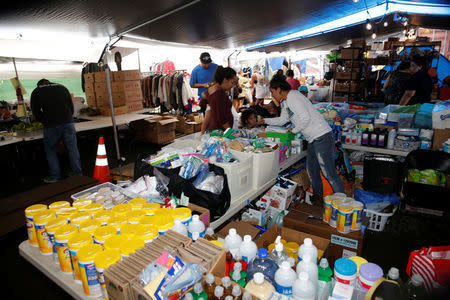 Mehana Kihoi hands out goods to Leilani Estate evacuees at the community organized Pu'uhonua o Puna, a center to help those affected by the recent lava eruption, in Pahoa, Hawaii, U.S., May 29, 2018. REUTERS/Marco Garcia