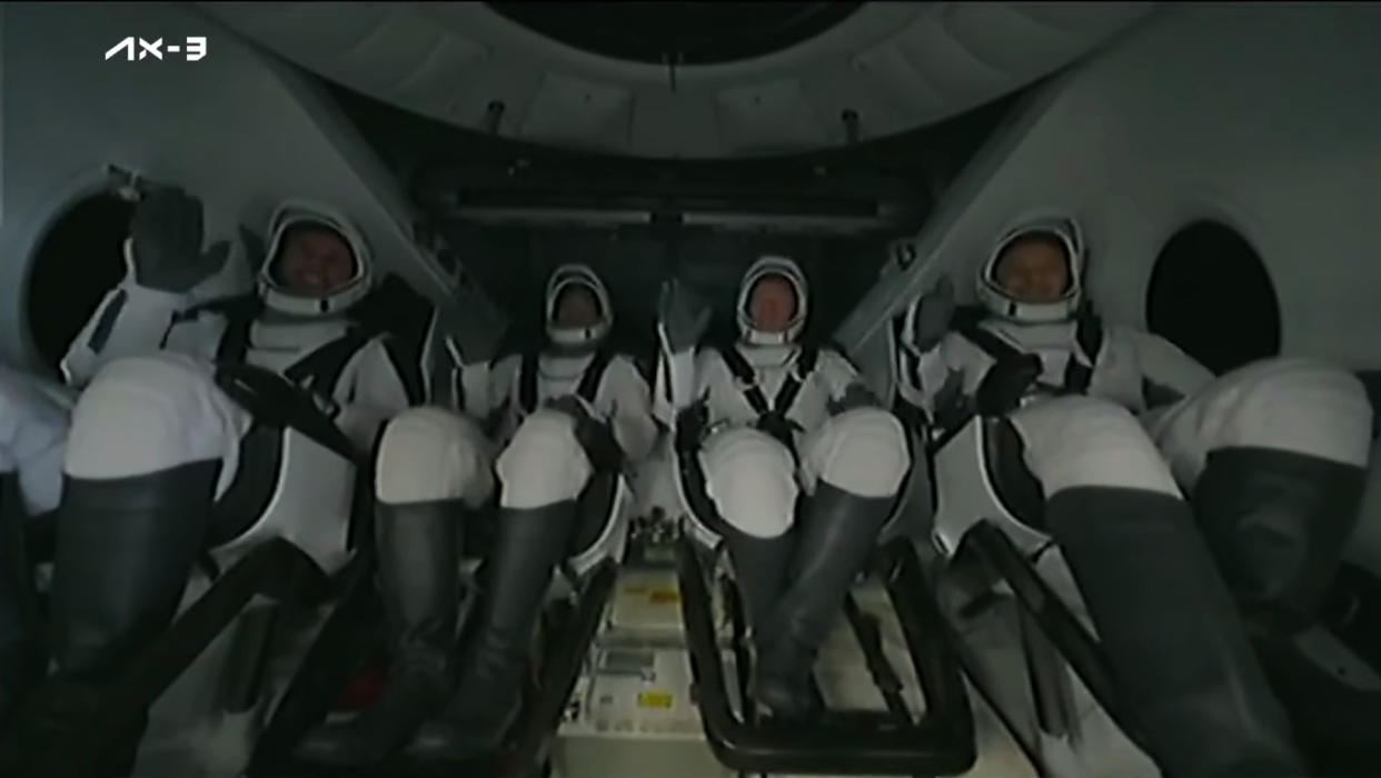  Four Ax-3 astronauts wave inside the SpaceX Dragon capsule Freedom after splashdown on Feb. 9, 2024. 