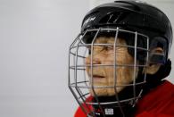 Valentina Fyodorova, 80, the captain of a senior women's hockey team, looks on before a match in Bereznik