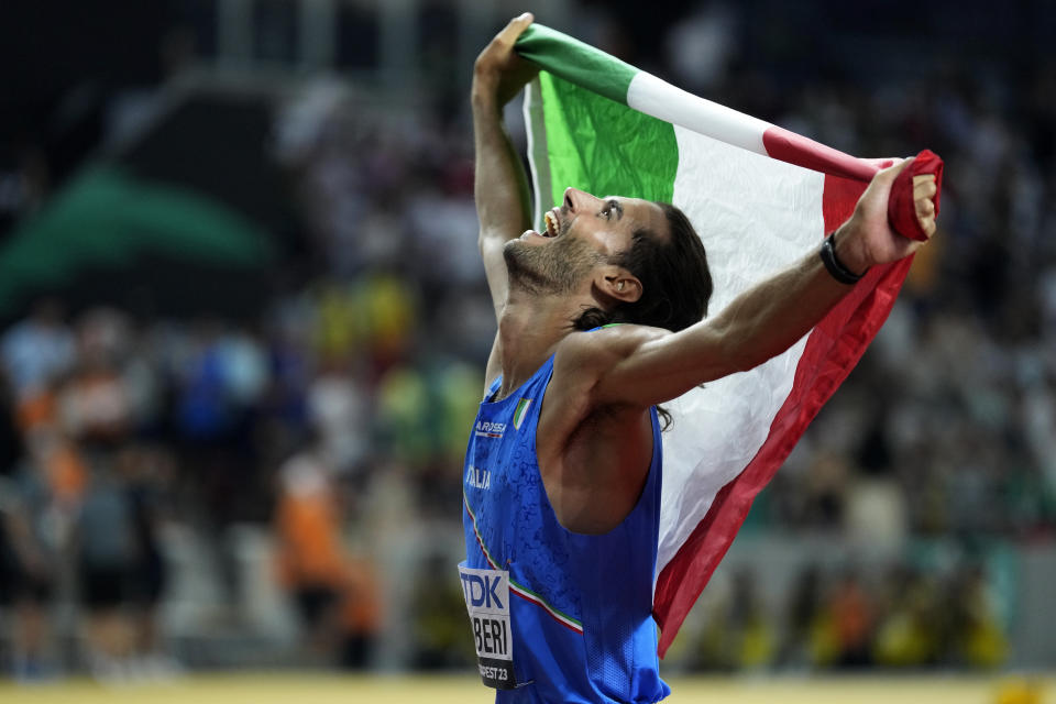 FILE - Gianmarco Tamberi, of Italy, celebrates after winning the gold medal in the Men's high jump final during the World Athletics Championships in Budapest, Hungary, on Aug. 22, 2023. Fencer Arianna Errigo and high jumper Gianmarco Tamberi were named as Italy’s flagbearers Monday, April 29, 2024 for the Paris Olympics opening ceremony. (AP Photo/Ashley Landis)