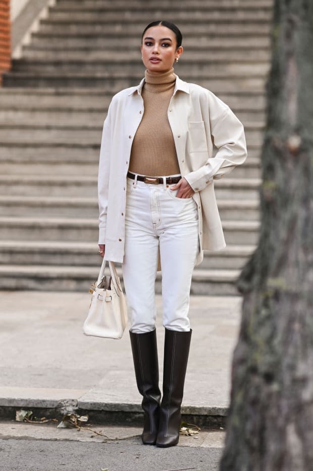 <em>Kelsey Merritt is seen wearing a Hermes white jacket, tan turtleneck sweater, white pants and brown belt, brown boots and white Hermes bag outside the Hermes show during Paris Fashion Week.</em><p>Daniel Zuchnik/Getty Images</p>