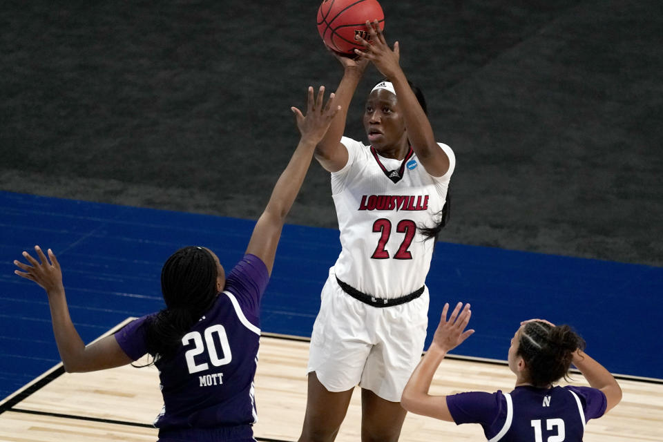 Louisville forward Elizabeth Dixon (22) shoots over Northwestern forward Paige Mott (20) during the first half of a college basketball game in the second round of the women's NCAA tournament at the Alamodome in San Antonio, Wednesday, March 24, 2021. (AP Photo/Charlie Riedel)