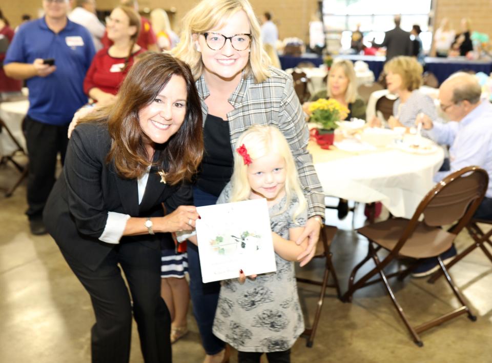 Karen Pence signs one of her books for Claire and Julie Van de Hoef during a fundraiser for Iowa Gov. Kim Reynolds on Sept. 21 in Des Moines.