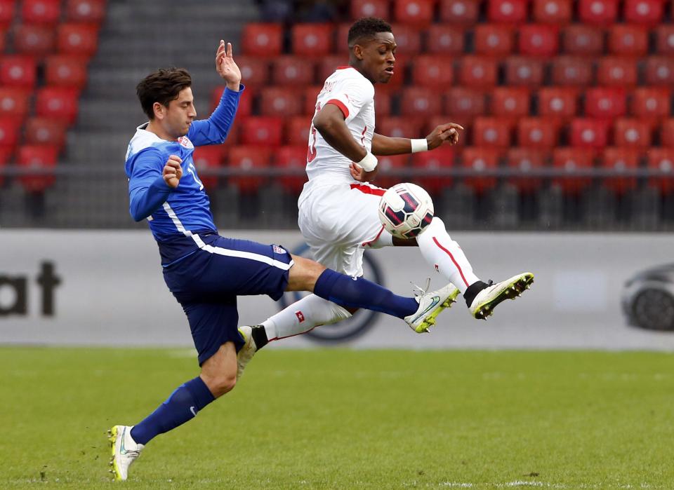 Moubandje of Switzerland fights for the ball with Bedova of the U.S during their international friendly soccer match at the Letzigrund Stadium in Zurich