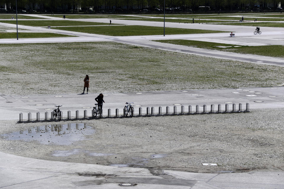 People walk in the Theresienwiese' area where the 'Oktoberfest' beer festival is held, in Munich, Germany, Monday, May 3, 2021. The world's largest beer festival 'Oktoberfest' was cancelled last year due to the coronavirus outbreak. (AP Photo/Matthias Schrader)