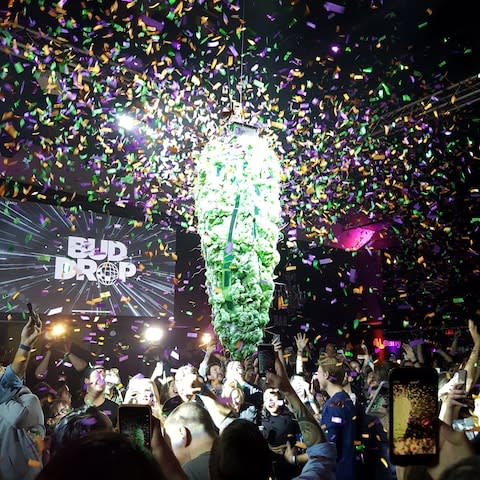 A decoration resembling a giant marijuana bud drops towards the crowd at midnight, during a party marking the legalisation of recreational cannabis in Toronto - Credit: Chandra Raye / Handout via REUTERS