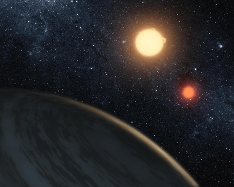 NASA handout image shows an artist's concept of the circumbinary planet Kepler-16b - the first planet known to definitively orbit two stars. The cold planet, with its gaseous surface, is not thought to be habitable. The largest of the two stars, a K dwarf, is about 69 percent the mass of our sun, and the smallest, a red dwarf, is about 20 percent the sun's mass. These star pairs are called eclipsing binaries. REUTERS/NASA/JPL-Caltech/T. Pyle/Handout