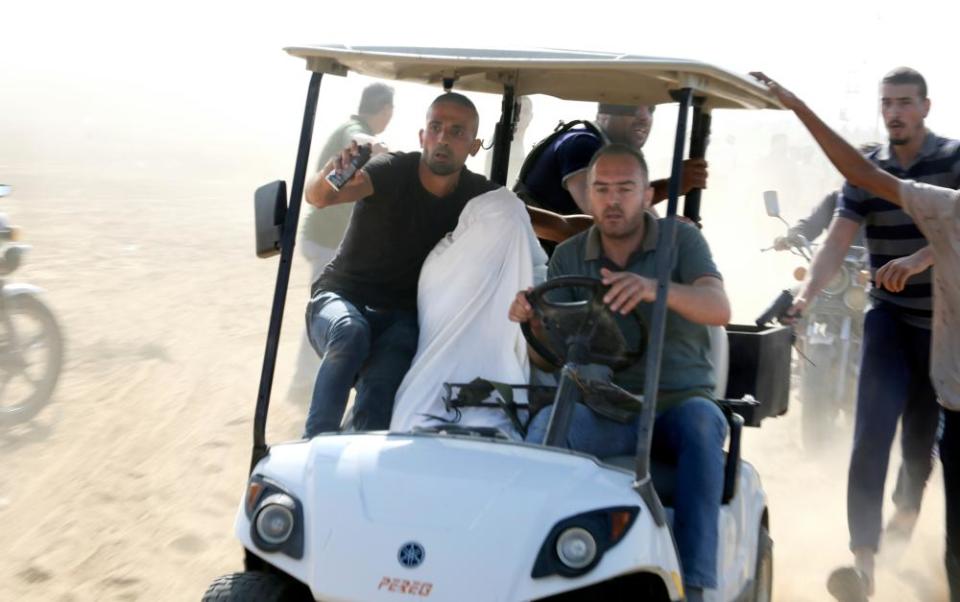 A captured Israeli civilian is taken to Gaza in a golf buggy