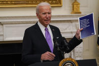 FILE - In this Jan. 21, 2021, file photo President Joe Biden holds a booklet as he speaks about the coronavirus in the State Dinning Room of the White House in Washington. (AP Photo/Alex Brandon, File)