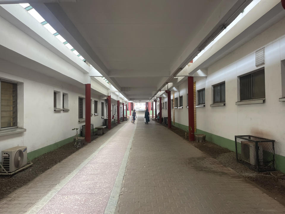 People walk along the corridor of the national hospital in Abuja, Nigeria, Wednesday, July 26, 2023. The Nigerian Association of Resident Doctors on Wednesday is on strike again, demanding better working conditions for its members. (AP Photo/Chinedu Asadu)