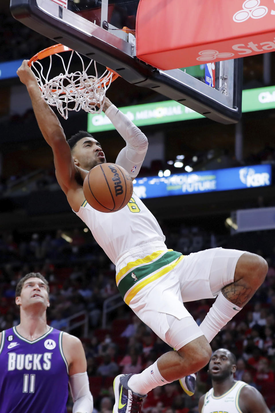 Houston Rockets forward K.J. Martin (6) dunks the ball over Milwaukee Bucks center Brook Lopez (11) during the first half of an NBA basketball game Sunday, Dec. 11, 2022, in Houston. (AP Photo/Michael Wyke)