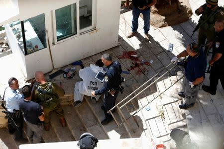 Israeli security forces gather at the scene of a stabbing attack in the West Bank city of Hebron September 19, 2016. REUTERS/Mussa Qawasma