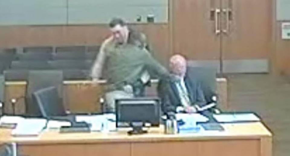 A still from the Arizona courtroom video appears to show defendant Lamont Payne punching his own lawyer (seated right) during a hearing.