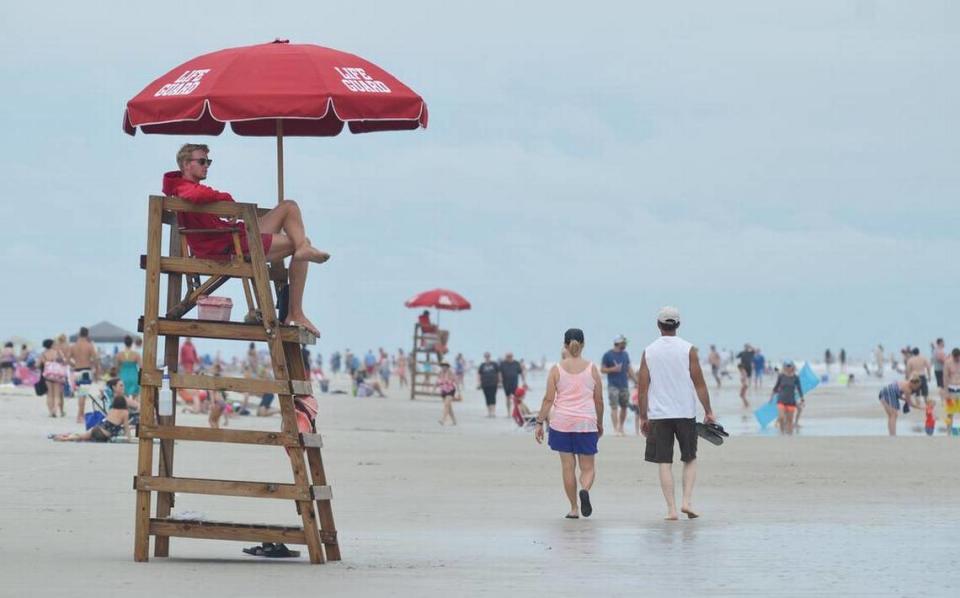 A Shore Beach Service lifeguard keeps watch over swimmers at the beach in July 2017.