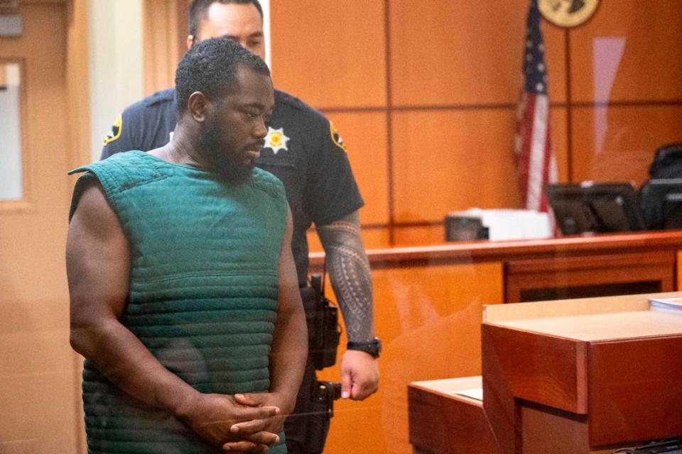 Niamkey Ange Amichia, 32, makes an initial appearance in Pierce County Superior Court on Friday, March 3, 2023, in Tacoma, Wash. Amichia, a former Puyallup police officer, is accused locally of raping a woman he met online on Oct. 7 of last year, according to charging papers for third-degree rape.