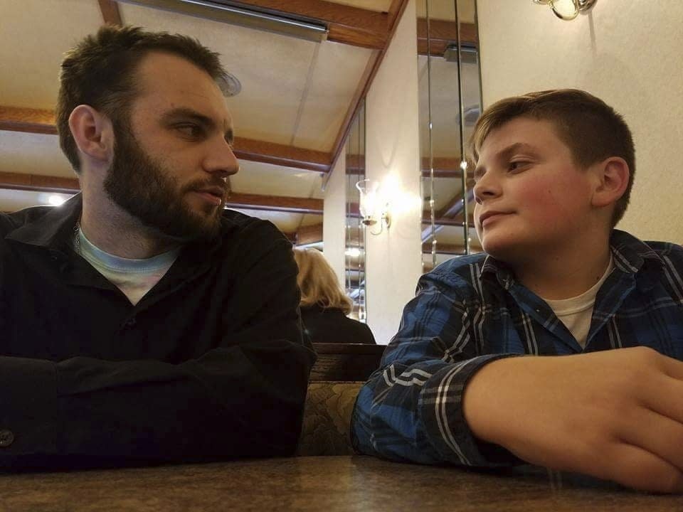 CORRECTS FIRST NAME TO TRENT FROM BRENT - In this Oct. 4, 2017, photo provided by Janel Firestone, Brandon Wentz, left, and his younger brother Trent Firestone sit in a restaurant in Minersville, Pa. Wentz's family is speaking out for the first time about his sudden death one year ago. Wentz was 22 when he became mayor of Mount Carbon, population 87. He died suddenly last November at age 24, just hours after resigning from office due to a family move. Wentz's family says he died of an overdose of heroin and fentanyl. His passing came near the end of a year that saw a record number of drug overdose deaths. (Janel Firestone via AP)