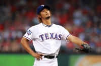 ARLINGTON, TX - APRIL 09: Yu Darvish #11 of the Texas Rangers reacts after giving up a walk against Munenori Kawasaki #61 of the Seattle Mariners at Rangers Ballpark in Arlington on April 9, 2012 in Arlington, Texas. (Photo by Ronald Martinez/Getty Images)