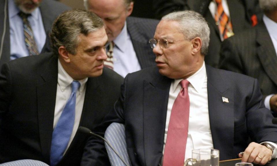 Colin Powell talks with George Tenet after his presentation to the UN security council in 2003.