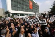 Zaman media group employees hold banners outside the headquarters of Zaman daily newspaper in Istanbul December 14, 2014. Turkish police raided media outlets close to a U.S.-based Muslim cleric on Sunday and detained 24 people including top executives and ex-police chiefs in operations against what President Tayyip Erdogan calls a terrorist network conspiring to topple him. REUTERS/Murad Sezer