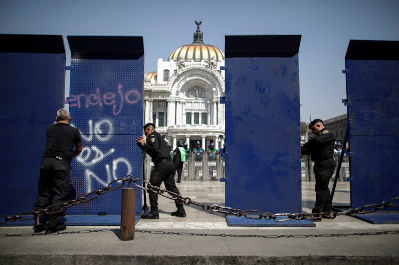 Security forces patrol as demonstrators take part in a protest against gender-based violence outside the Palacio de Bellas Artes in Mexico City