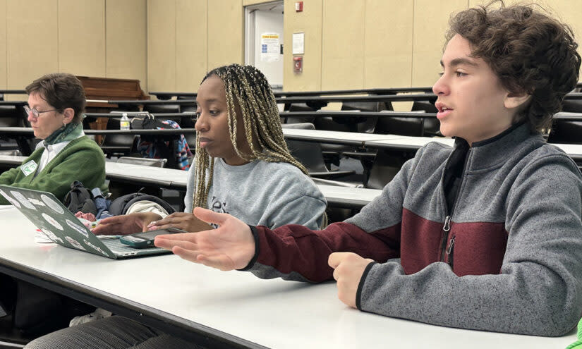 Students at A School Without Walls give presentations on learning, which are critiqued by fellow students and visitors. Joseph Luna Pisch (right) focused on rising transit fares. (Beth Fertig)