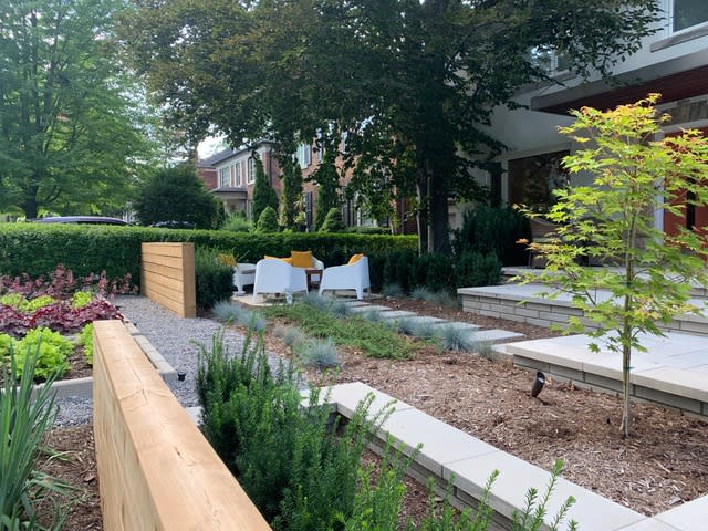 a small privacy fence in a front yard