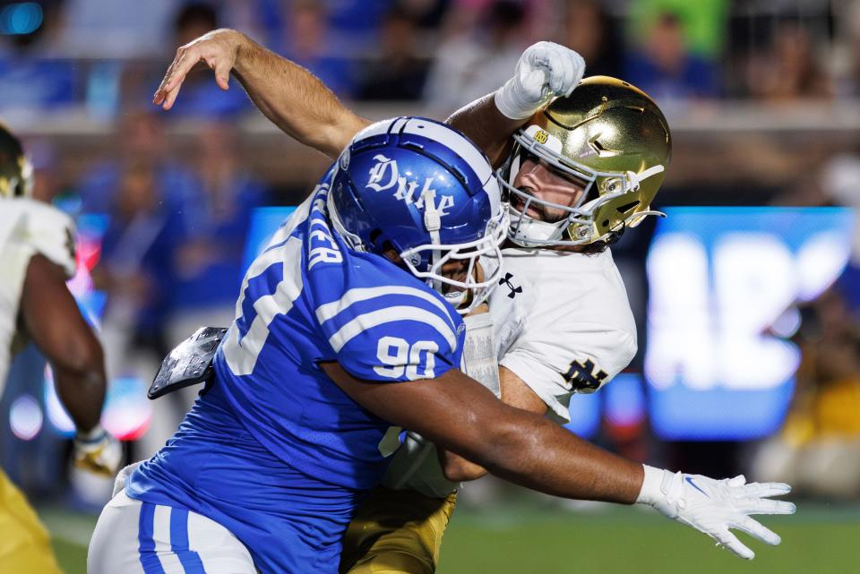 Duke's DeWayne Carter, a Pickerington Central graduate, hits Notre Dame quarterback Sam Hartman during their game Sept. 30.