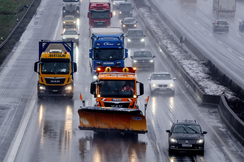A salt truck drives on the highway as rain sets in combined with low temperatures in Frankfurt, Germany, Wednesday, Jan. 17, 2024. (AP Photo/Michael Probst)