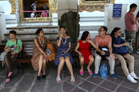 FILE PHOTO - Chinese tourists take a break at Wat Pho in Bangkok, Thailand, October 3, 2016. REUTERS/Athit Perawongmetha/Files Photo