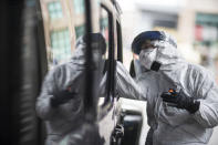 A passenger gets swabbed for COVID-19 at a testing site at the convention center in Providence, R.I, Tuesday, Dec. 1, 2020. Amid the coronavirus resurgence, states have begun reopening field hospitals to handle an influx of sick patients that is pushing health care systems — and their workers — to the breaking point. Hospitals are bringing in mobile morgues. And funerals are once again being livestreamed or performed as drive-by affairs. (AP Photo/David Goldman)