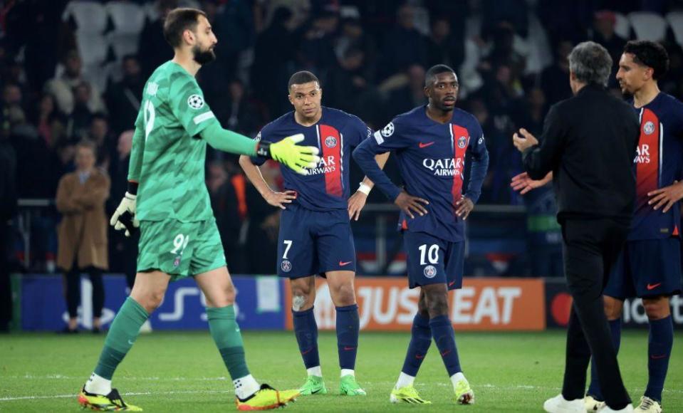 PSG players stand stunned at full-time after losing to Dortmund
