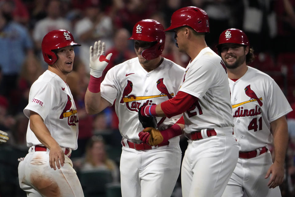 St. Louis Cardinals' Andrew Knizner is congratulated by teammates Tommy Edman, left, Lars Nootbaar (21) and Alec Burleson (41) after hitting a grand slam during the eighth inning of a baseball game against the Milwaukee Brewers Monday, May 15, 2023, in St. Louis. (AP Photo/Jeff Roberson)